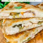 Pin of Hatch Green Chile Chicken Quesadillas pieces stacked on a tower on a wood board with title at top