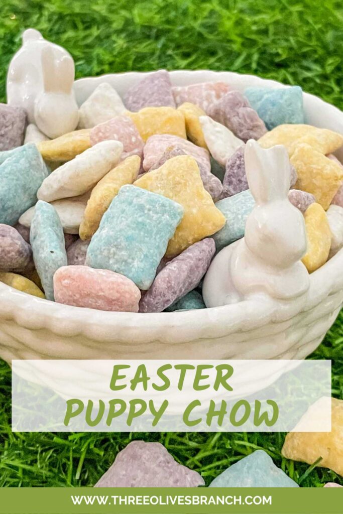 Pin of Easter Puppy Chow in a white ceramic bowl with small bunnies sitting on green grass with title