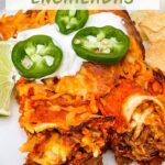 Pin of two Shredded Beef Enchiladas on a white plate with sour cream and jalapenos on them. Title at top.