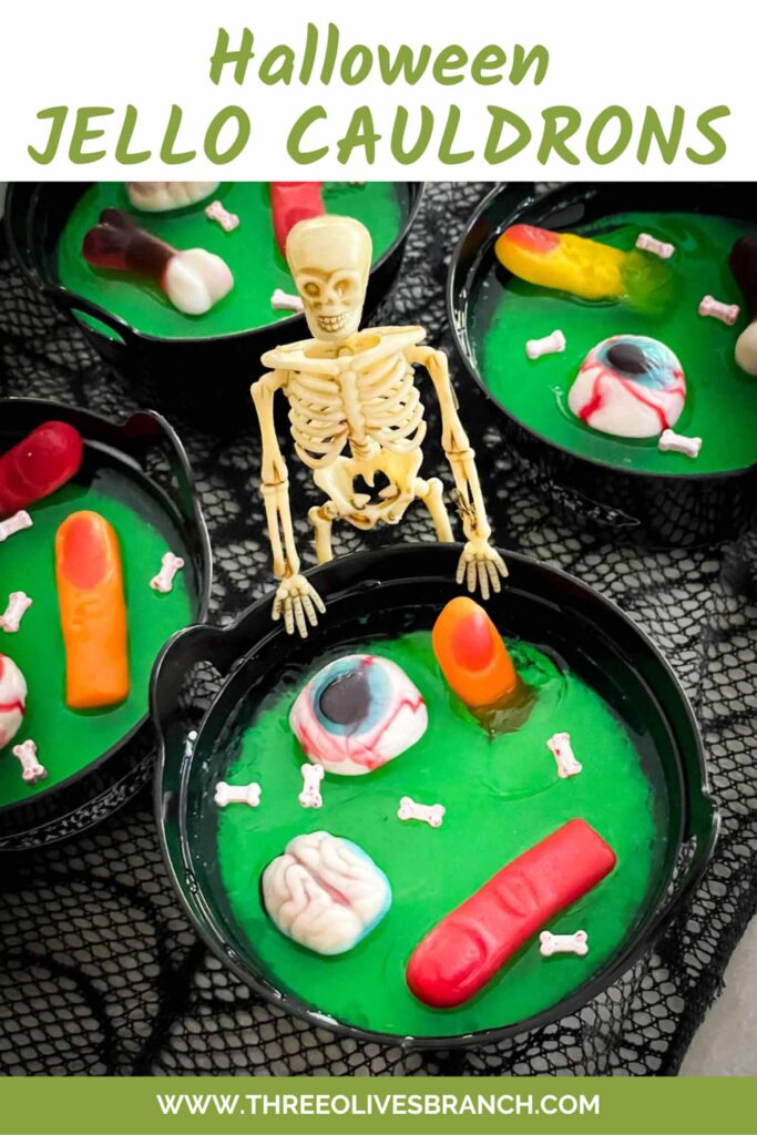 Pin of a skeleton standing at a Halloween Jello Cauldron with gummy body parts in it and title at top