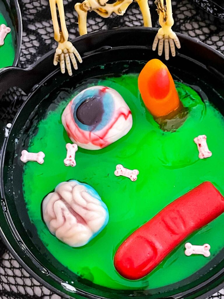 Close view of the cauldron with gummy body parts in green gelatin