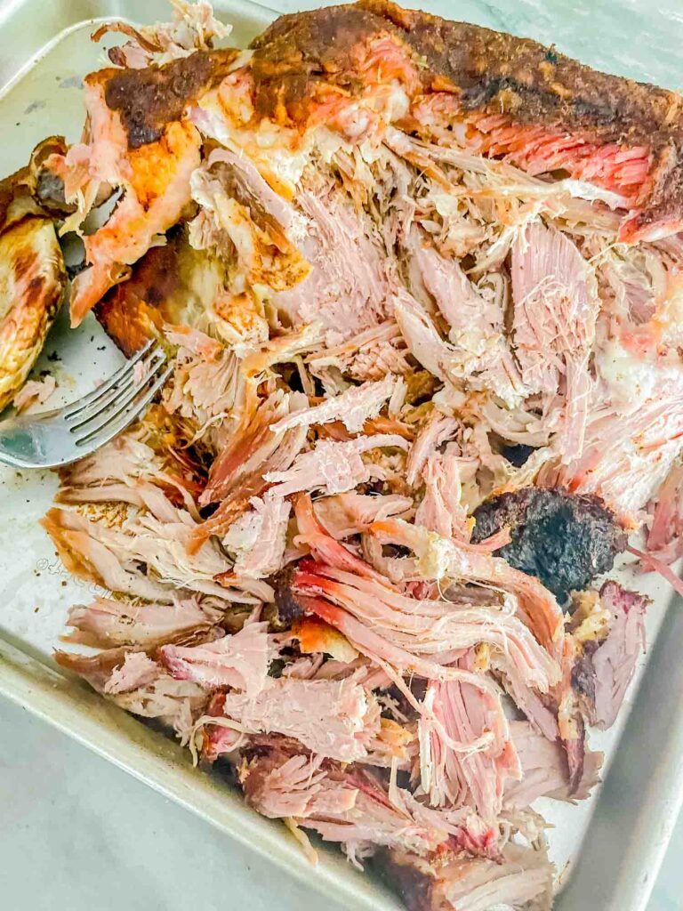 A baking sheet full of shredded Smoked Pork Butt