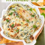 Pin of Easy Spinach Artichoke Dip in a dish shaped like an artichoke sitting on a wood board with title at top