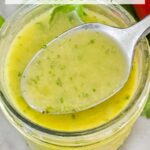 Pin of Cilantro Lime Vinaigrette Salad Dressing in a jar with a spoon coming out of it and title at top