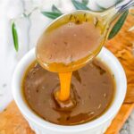 Pin of Honey Mustard Glaze being poured into a small white bowl with title at top