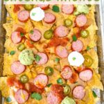 Pin of Sausage Beer Cheese Nachos on a baking sheet with title at top