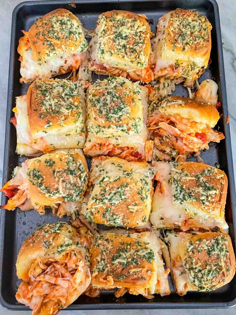 Top view of the Chicken Parm Sliders all cut apart on a baking sheet