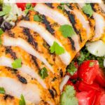 Pin of sliced Cilantro Lime Grilled Chicken on a salad with title at top