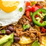 Pin of Pork Carnitas Green Chilaquiles with Eggs up close with title at top