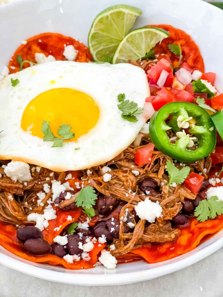 Shredded Beef Red Chilaquiles in a bowl