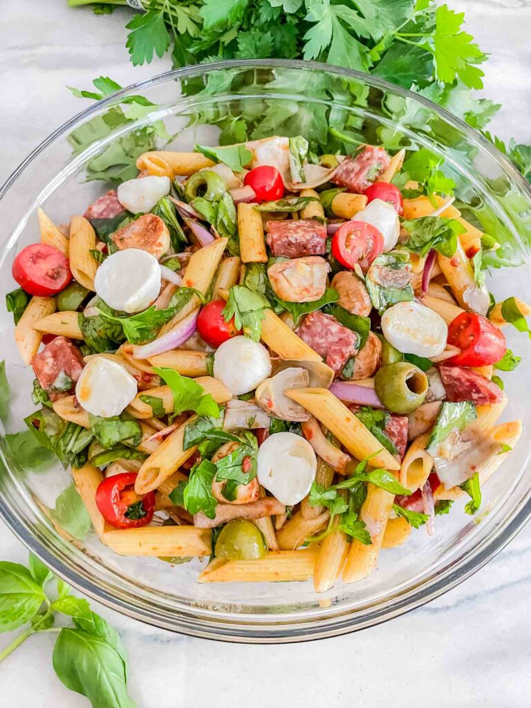 Top view of Italian Antipasto Pasta Salad in a glass bowl on a counter