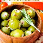 Pin of Blue Cheese Stuffed Olives in a small wood bowl with title at top