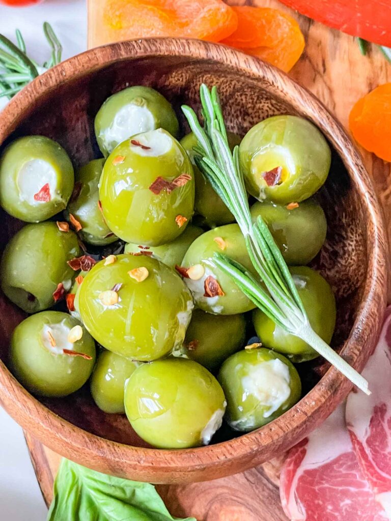 Top view of Blue Cheese Stuffed Olives closer up in a wood bowl