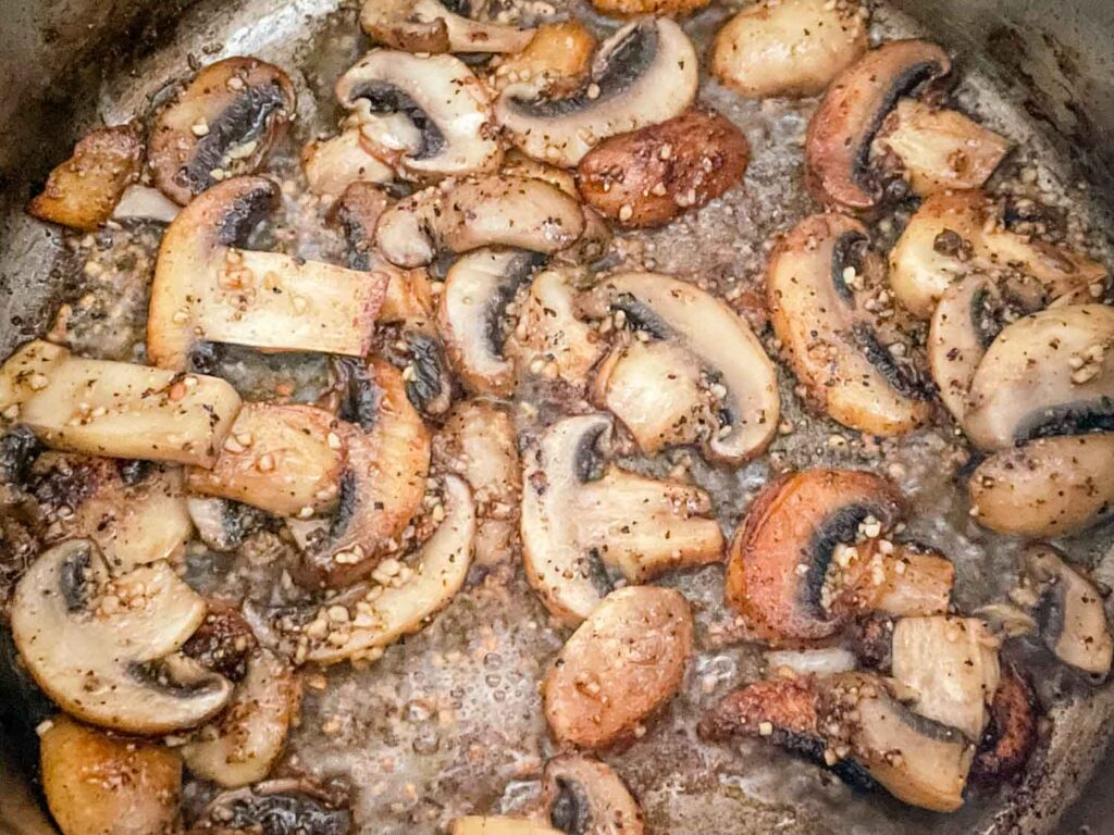 The mushrooms cooking in a pot