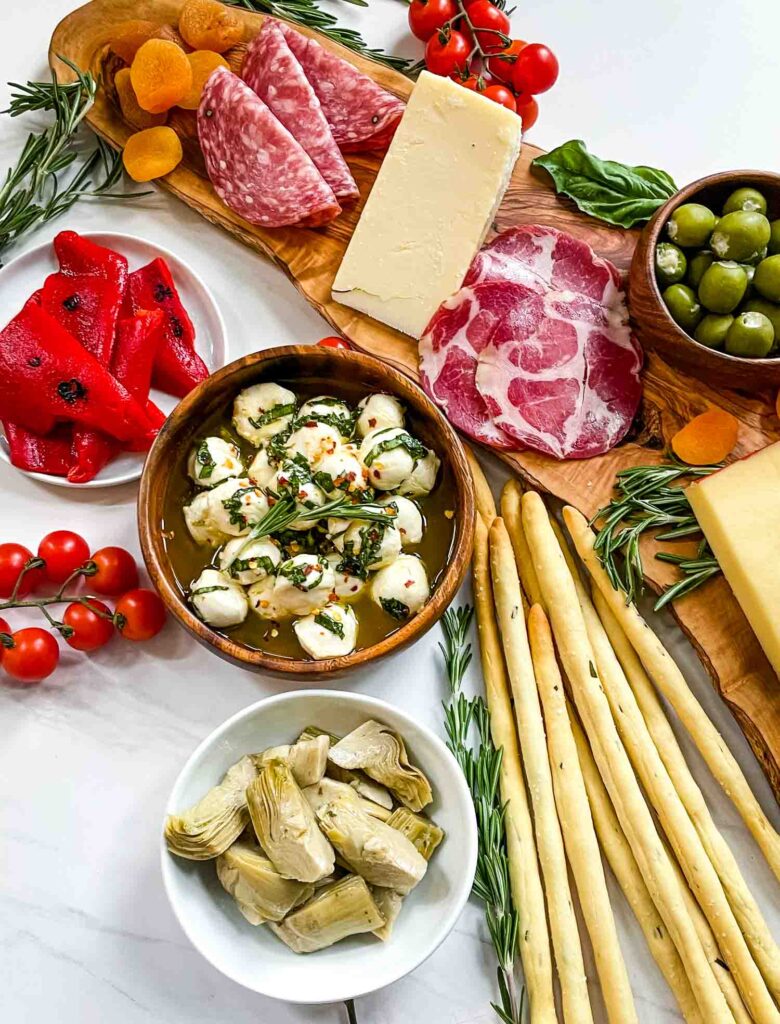 Marinated Mozzarella Balls with our Italian Antipasti Charcuterie Board on a white counter