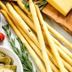 Pin of Rosemary Grissini breadsticks in a pile with title at top