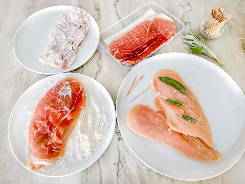 The different stages of preparing and dredging the chicken, done on a counter.