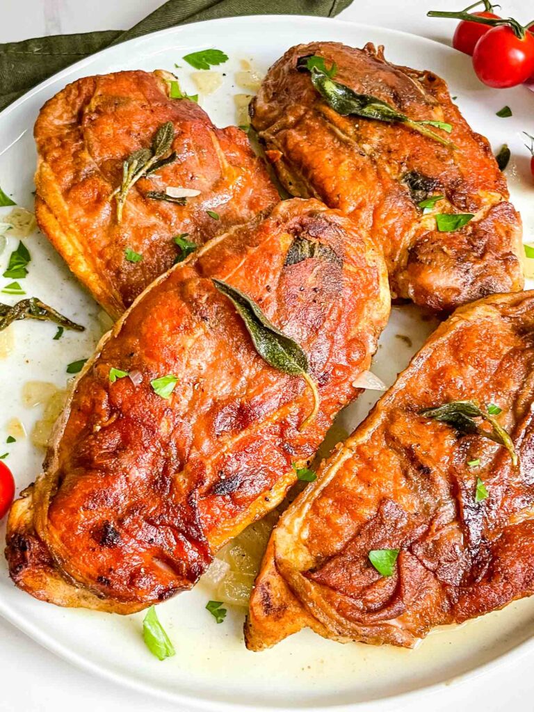 Chicken Saltimbocca alla Romana piled up on a white plate.