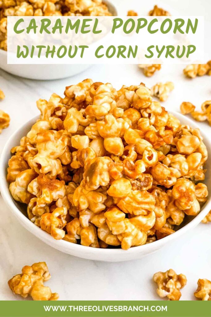 Pin of Homemade Caramel Popcorn Recipe (without Corn Syrup) in a white bowl on a counter with title at top.