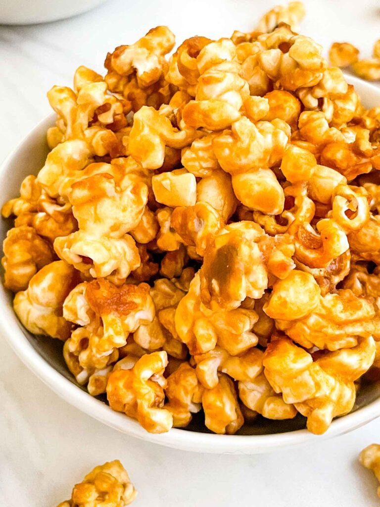 A close view of Homemade Caramel Popcorn Recipe (without Corn Syrup) in a small bowl.