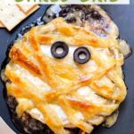 Pin of Halloween Mummy Wrapped Baked Brie Recipe with title.