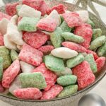 A silver bowl full of Holly Jolly Christmas Puppy Chow.