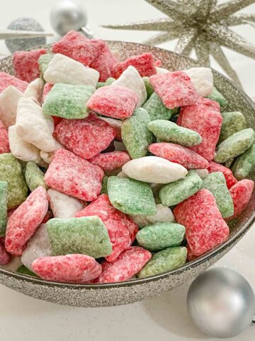 A silver bowl full of Holly Jolly Christmas Puppy Chow.