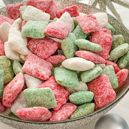 A silver bowl full of Holly Jolly Christmas Puppy Chow.