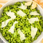 Pin looking down on a bowl of Hazelnut Spinach Pesto Cavatappi pasta with title at top.