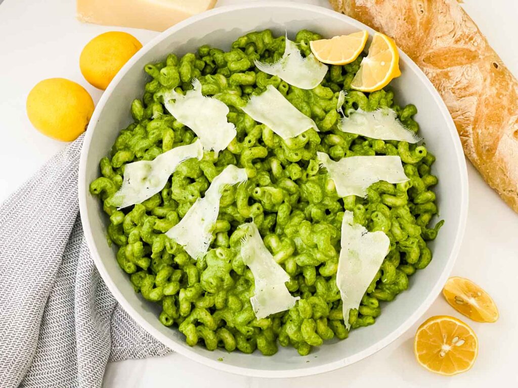 Looking down on a bowl full of Hazelnut Spinach Pesto Cavatappi on a counter.