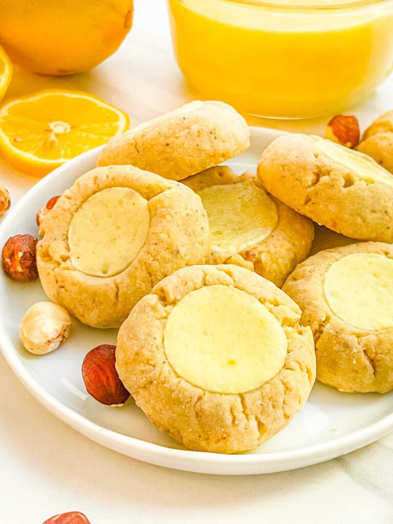 A closer view of the Italian Hazelnut Lemon Curd Thumbprint Cookies on a small plate.