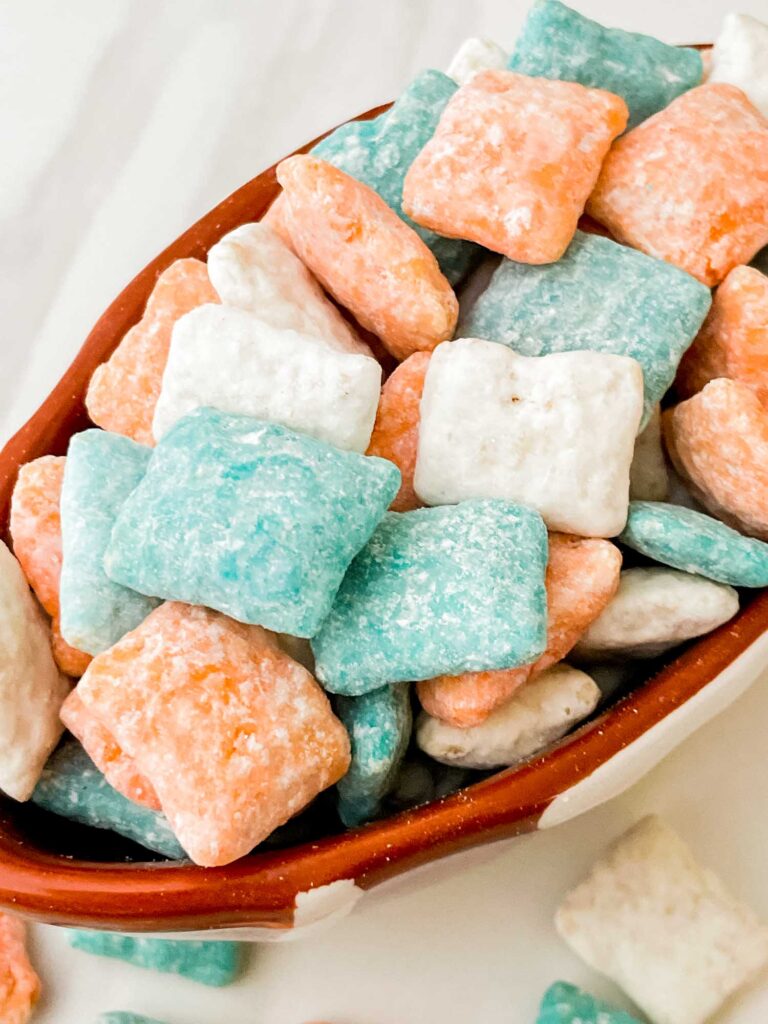 Close view of turqu9oise, orange, and white Miami Dolphins Puppy Chow.