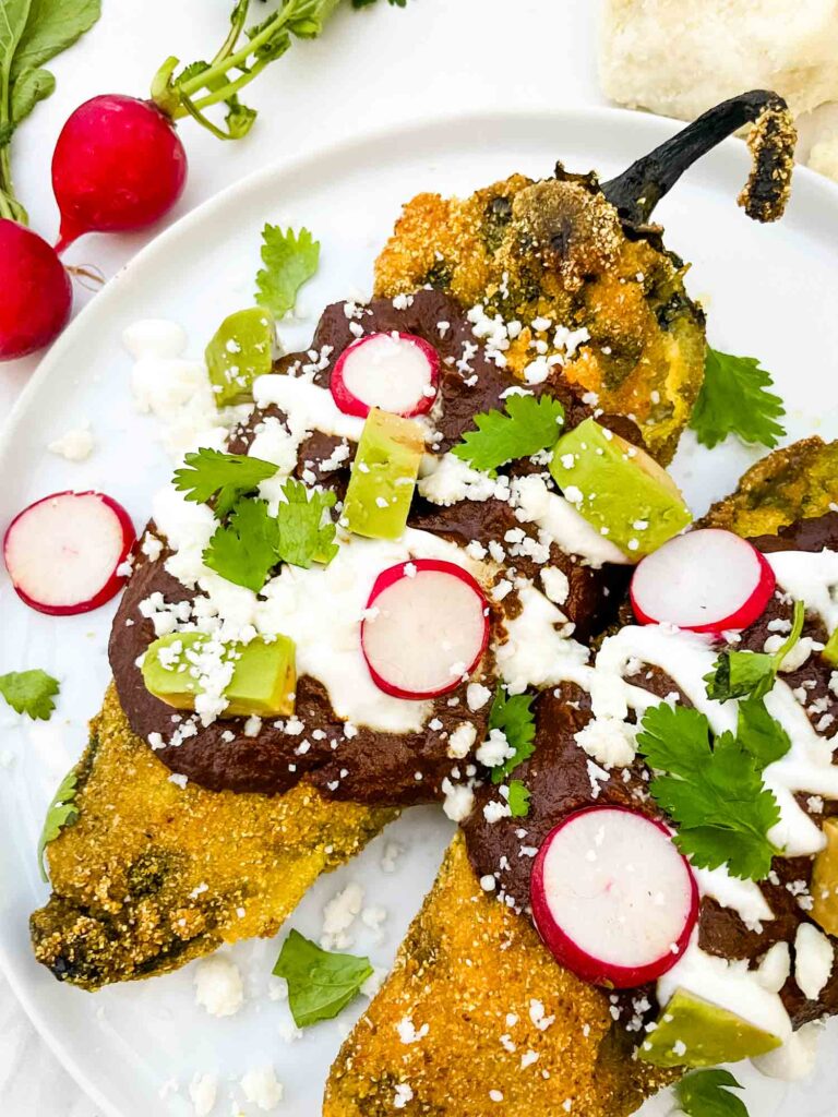 Close view of a Mole Chile Relleno on a plate.