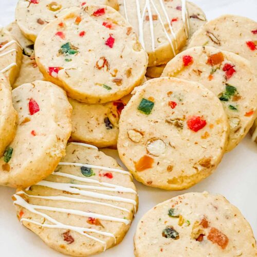 A pile of Panettone Fruitcake Shortbread cookies on a counter.