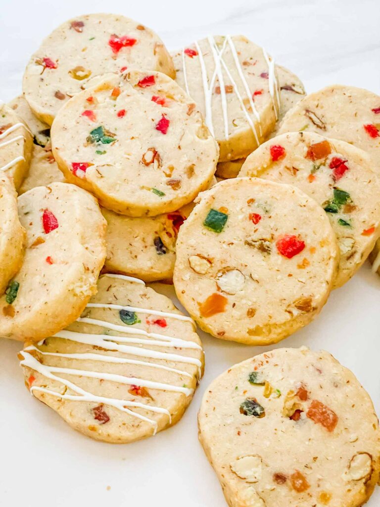 A pile of Panettone Fruitcake Shortbread cookies on a counter.