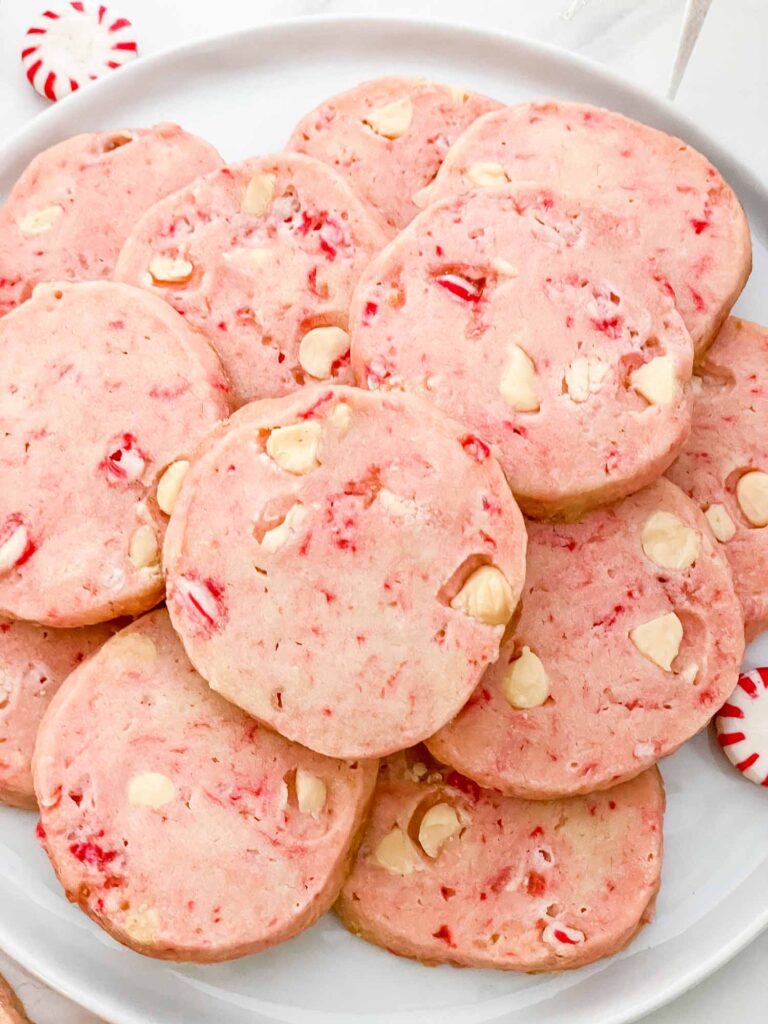 A close view of pink White Chocolate Peppermint Shortbread in a pile before being decorated.