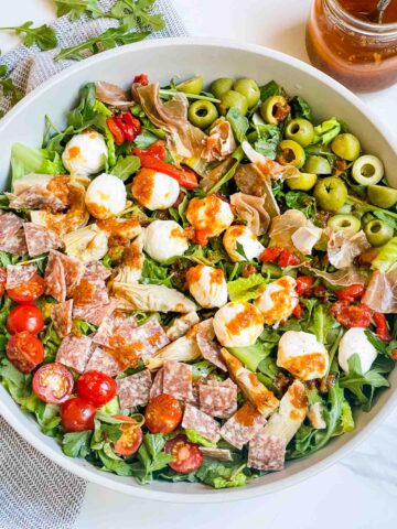 Looking down on a large bowl of the Best Italian Chopped Salad Recipe with ingredients in rows.