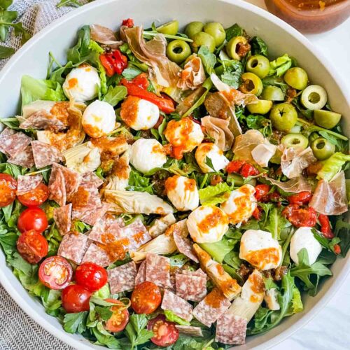 Looking down on a large bowl of the Best Italian Chopped Salad Recipe with ingredients in rows.