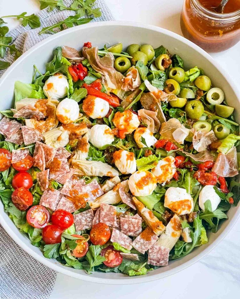 Looking down on a large bowl of the Best Italian Chopped Salad Recipe with ingredients in rows.