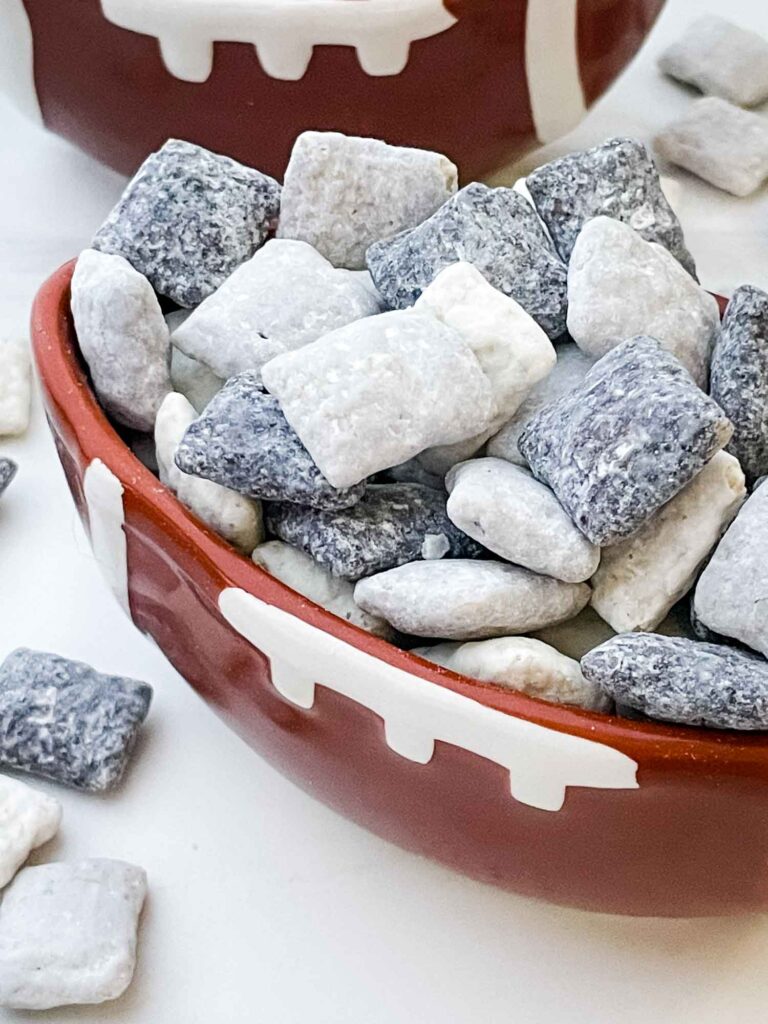 A closer view of the black, silver, and white Las Vegas Raiders Puppy Chow in a football bowl.