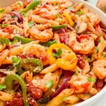 Pin of Copycat Olive Garden Shrimp Primavera Pasta in bowl with title at top.