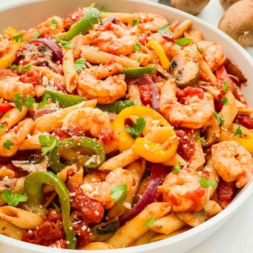 The Copycat Olive Garden Shrimp Primavera Pasta in a large bowl garnished with parsley.