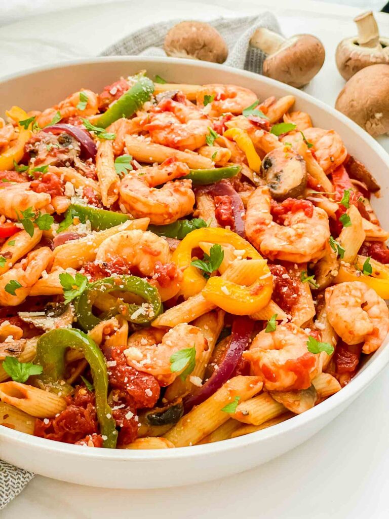 The Copycat Olive Garden Shrimp Primavera Pasta in a large bowl garnished with parsley.