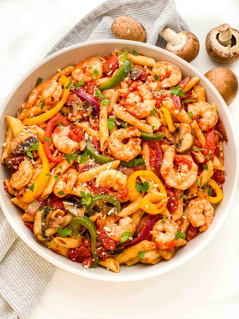 Looking down on a large bowl full of the Copycat Olive Garden Shrimp Primavera Pasta.