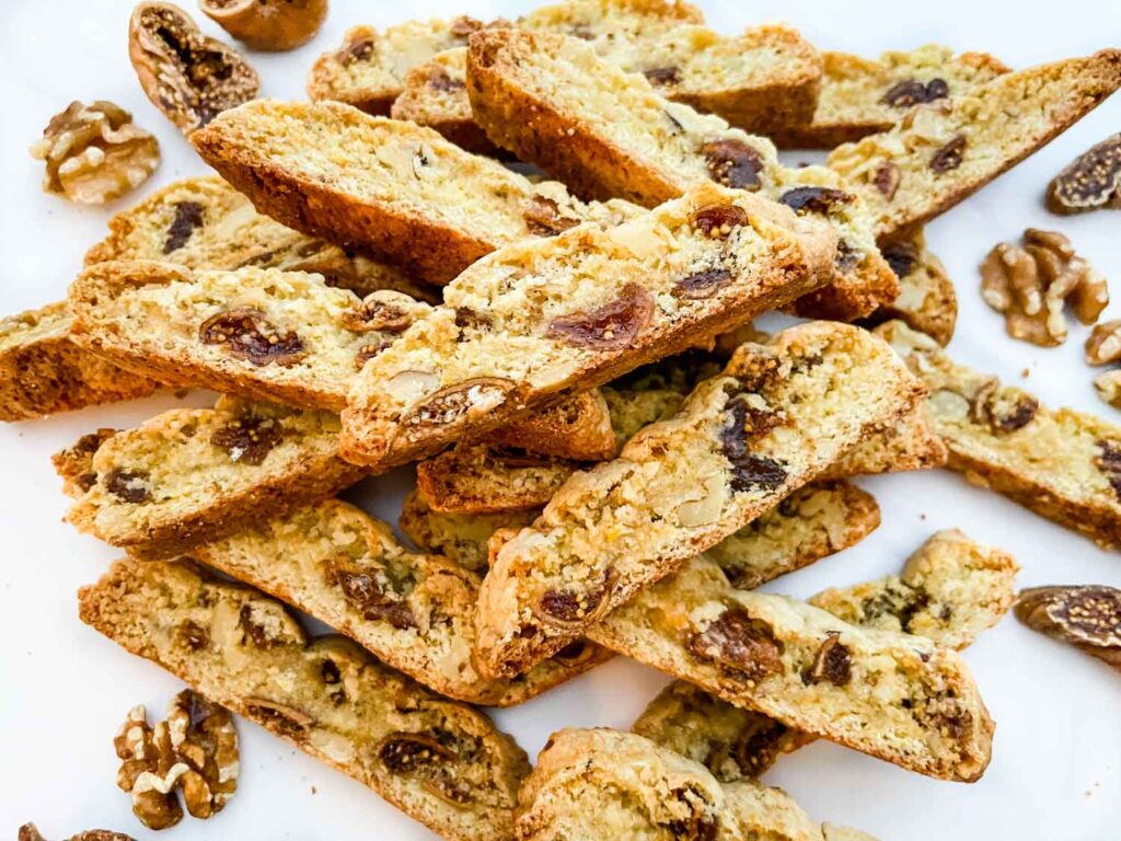 A pile of Fig Walnut Biscotti cookies on a counter.