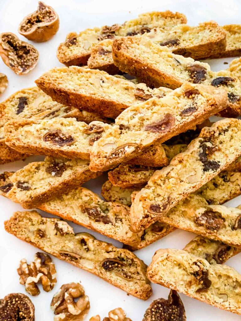 A pile of Fig Walnut Biscotti cookies on a counter.