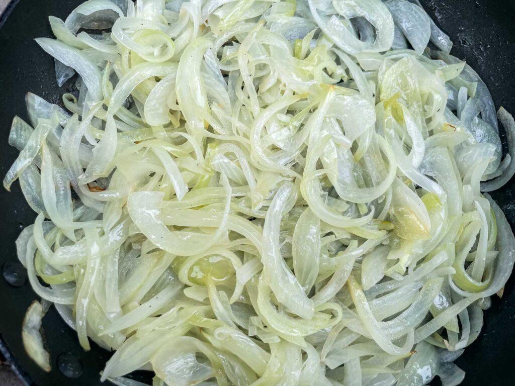 A skillet full of sauteed onions.