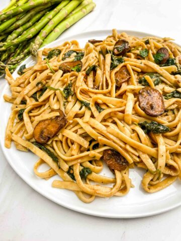 A white plate full of Mushroom Marsala Wine Sauce pasta.