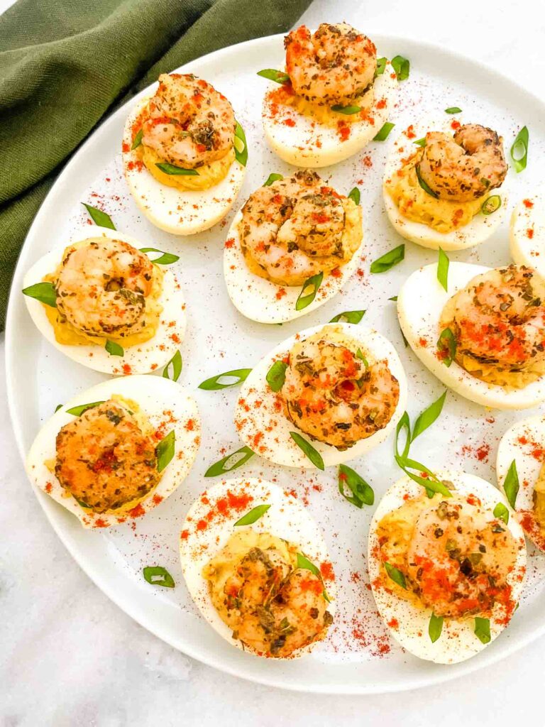 Cajun Shrimp Deviled Eggs on a white plate on a counter.