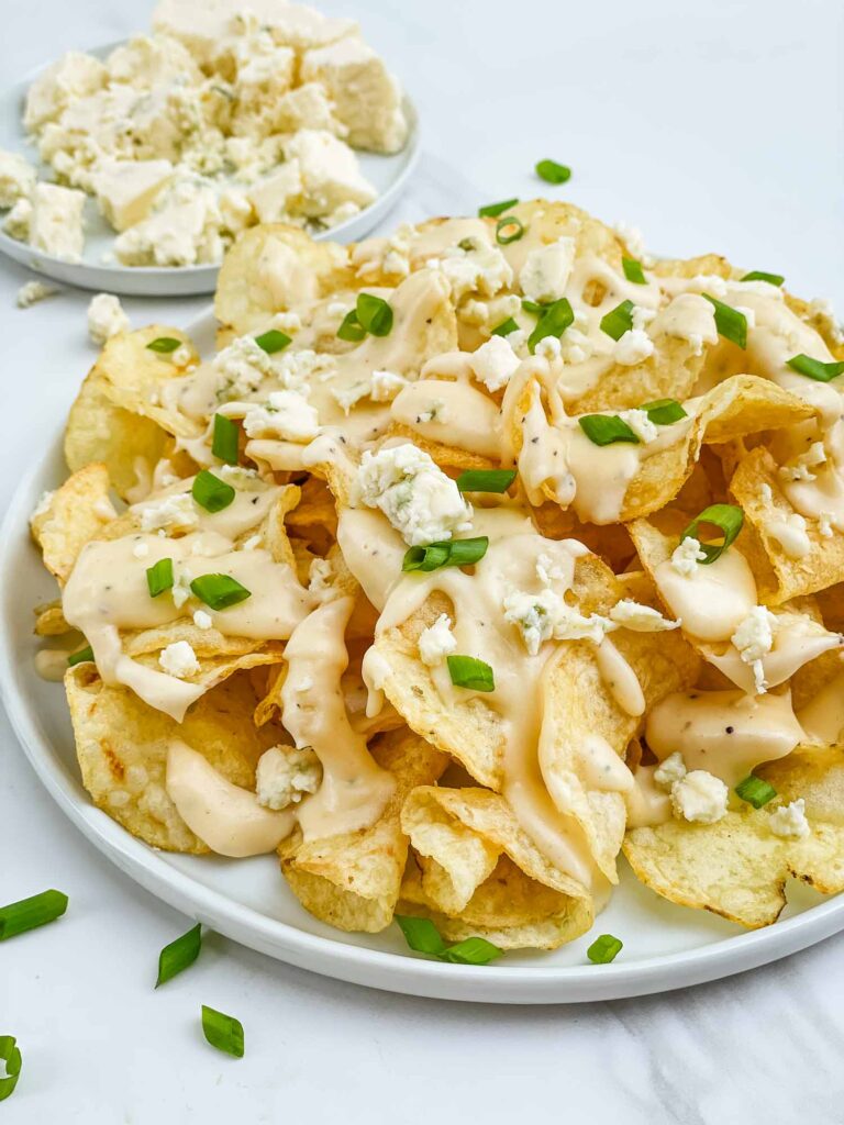 A plate of Copycat Bennigan's Blue Cheese Chips on a counter.